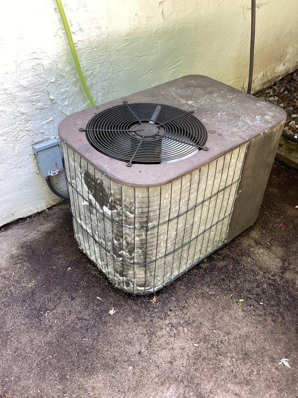 Responded to service call for furnace displaying error code R1053. Upon arrival, diagnosed code as a fan speed fault and confirmed system operation. Performed cleaning of outdoor condenser coil, which showed significant dirt accumulation, debris buildup, and weathering on the unit's louvers and exterior surfaces.