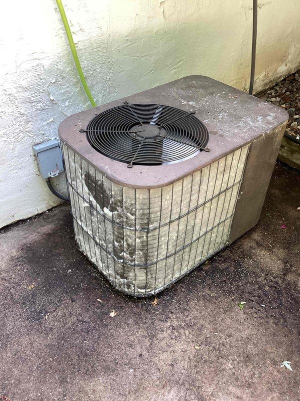 Responded to service call for furnace displaying error code R1053. Upon arrival, diagnosed code as a fan speed fault and confirmed system operation. Performed cleaning of outdoor condenser coil, which showed significant dirt accumulation, debris buildup, and weathering on the unit's louvers and exterior surfaces.
