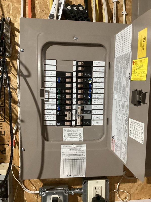 Responded to multiple circuit breaker tripping issues affecting refrigerator, dishwasher, and garage door circuits. Upon inspection, discovered refrigerator drawing 12.5 amps on an undersized 15-amp breaker, dishwasher sharing circuit with wine fridge causing overload, and loose connections at theater projector outlet. Corrected faulty connections at projector outlet and relocated wine cooler to existing dedicated outlet under sink to resolve circuit overload conditions.