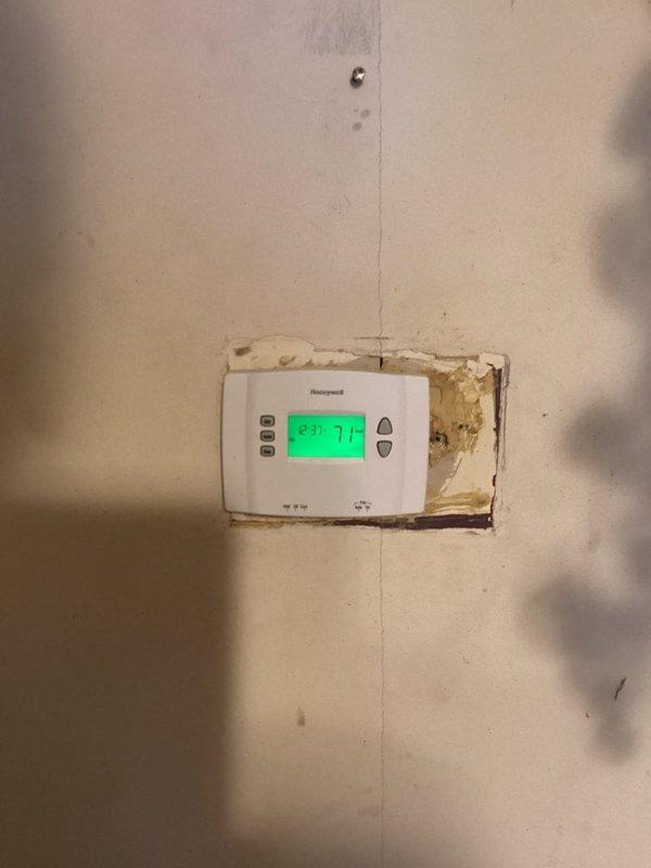 Responded to no cooling complaint and diagnosed thermostat malfunction caused by incorrectly installed batteries. Corrected battery polarity to restore thermostat operation and performed complete system maintenance on air conditioning unit. Noted significant vegetation overgrowth around outdoor condenser unit that should be cleared to maintain proper airflow and system efficiency.