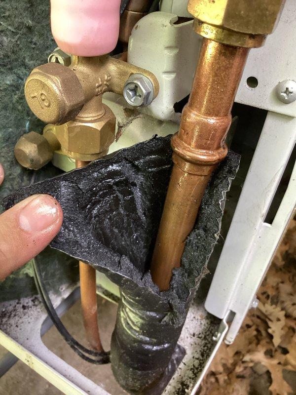Responded to no cooling complaint on air conditioning system. Upon inspection, discovered refrigerant leak at flare fitting connection on copper refrigerant line. Identified failed press-on flare fitting as source of refrigerant loss causing inadequate cooling performance. Documented leak location with photos showing deteriorated fitting and moisture present at connection point. Recommended replacement of defective press-on flare fittings to restore proper system refrigerant charge and cooling capacity.