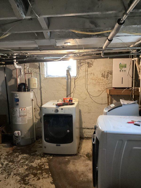 Completed installation of a 40-gallon power vent water heater and a one-piece Water Right Impressions water softener system in the basement utility area. Established all necessary plumbing connections, configured the power vent exhaust system, and mounted the digital control panel for system operation.