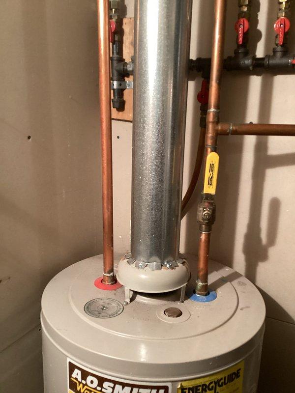 Responded to customer concern regarding aging water heater. Upon arrival, assessed existing A.O. Smith tanked water heater unit and determined replacement was necessary due to age and condition. Completed full water heater replacement, installing new unit with proper copper pipe connections, shut-off valves, and venting system. Ensured all plumbing connections were properly soldered and sealed, with red-handled ball valves installed for maintenance access. System tested and verified operational upon completion.