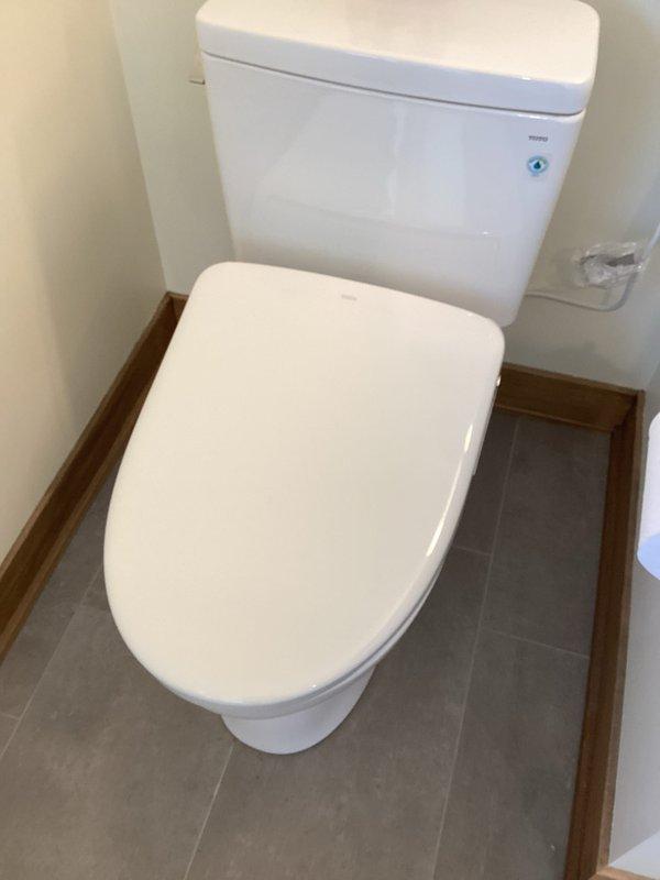 Completed installation of customer-supplied bidet attachment on existing two-piece toilet in residential bathroom. Unit was successfully mounted to toilet bowl, water supply line connected, and all control functions tested to ensure proper operation. Installation verified with no leaks detected at connection points.
