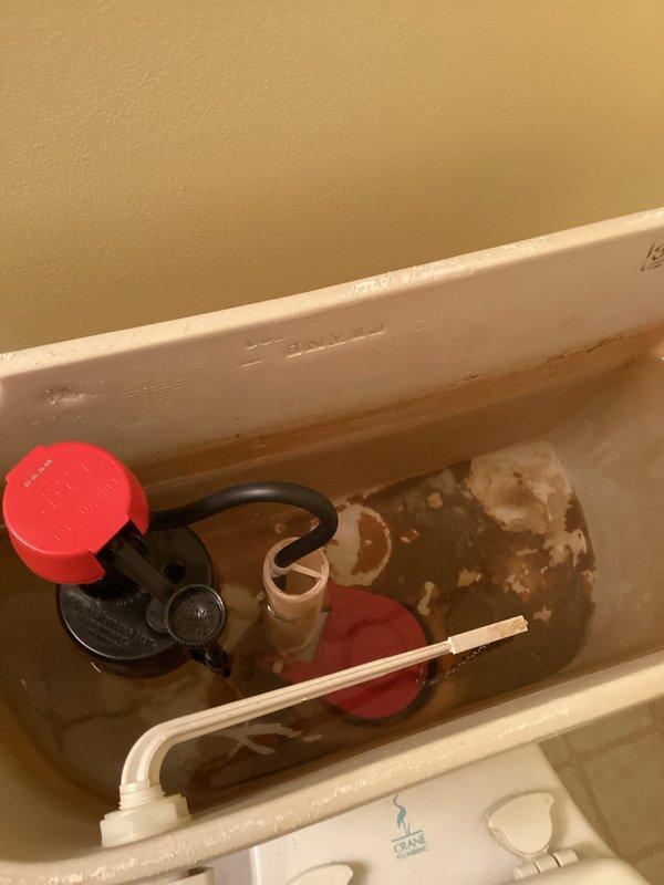 Responded to service call for two toilet malfunctions in residential bathroom. Primary issue involved toilet continuously running after flush cycle completion. Secondary issue concerned inadequate water refill in bowl after flushing. 

Upon inspection, identified failed fill valve and deteriorated flapper as root causes. Tank interior exhibited significant water discoloration and mineral sediment buildup, indicating hard water conditions and component degradation. Fill valve assembly showed wear on float mechanism affecting proper shutoff function. Rubber flapper valve demonstrated loss of seal integrity, preventing complete closure and causing constant water flow into bowl.

Performed complete toilet rebuild, replacing fill valve assembly and flapper valve with new components. Restored proper flush and refill operation to both fixtures. System tested and verified functional upon completion.