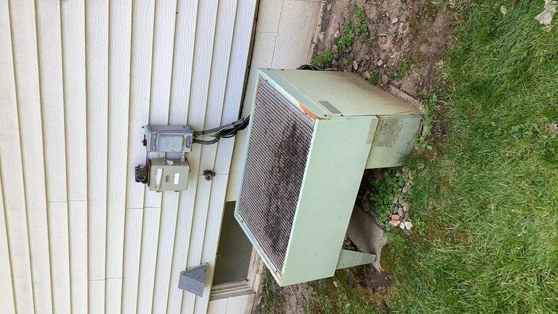 Responded to no cooling complaint on residential air conditioning system. Upon arrival, found indoor temperature at 87°F with unit cycling and producing abnormal noise. Diagnosed failed condenser fan motor preventing proper heat rejection. Given the age and overall condition of the 10+ year old system, recommended full system replacement rather than repair. Installed new air filter as requested and discussed maintenance options and basic thermostat replacement with homeowner.