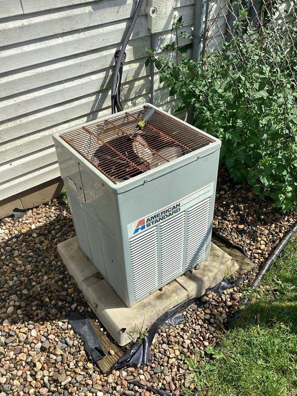 Responded to cooling complaint on American Standard residential AC system. Found condenser coil heavily plugged with debris restricting airflow and system slightly low on refrigerant charge. Performed condenser coil cleaning to restore proper heat exchange and prepared estimate for refrigerant recharge and further repairs.