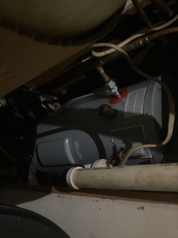Responded to service call for leaking water heater. Upon arrival, confirmed active leak from tanked water heater requiring immediate replacement. Removed existing failed unit and installed new tanked water heater. Connected all necessary water supply lines, pressure relief valve, and drain pan. Verified proper venting, tested all connections for leaks, and confirmed unit operational. Also observed water filtration system with dual canister filters installed under sink during inspection of plumbing connections.