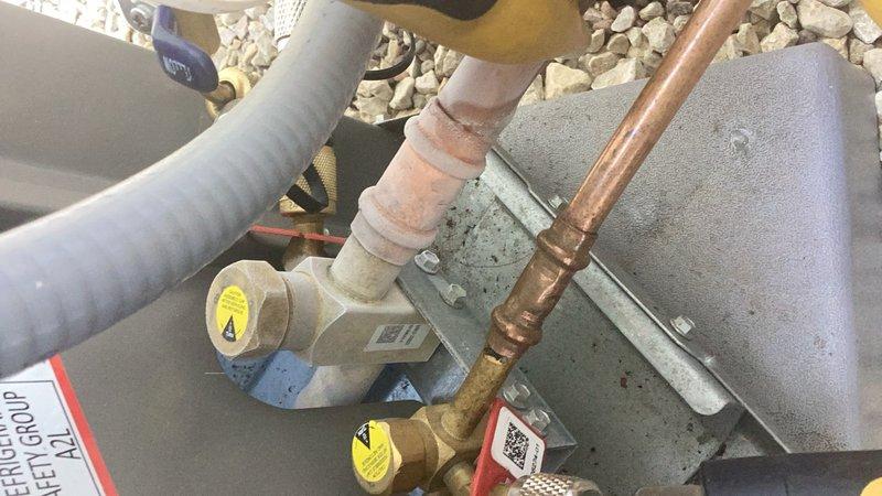 Responded to no cooling complaint on residential air conditioning system installed five months prior. Upon inspection, identified refrigerant leak at press fitting connection on service valve. Replaced defective service valve to restore system integrity and proper cooling operation.