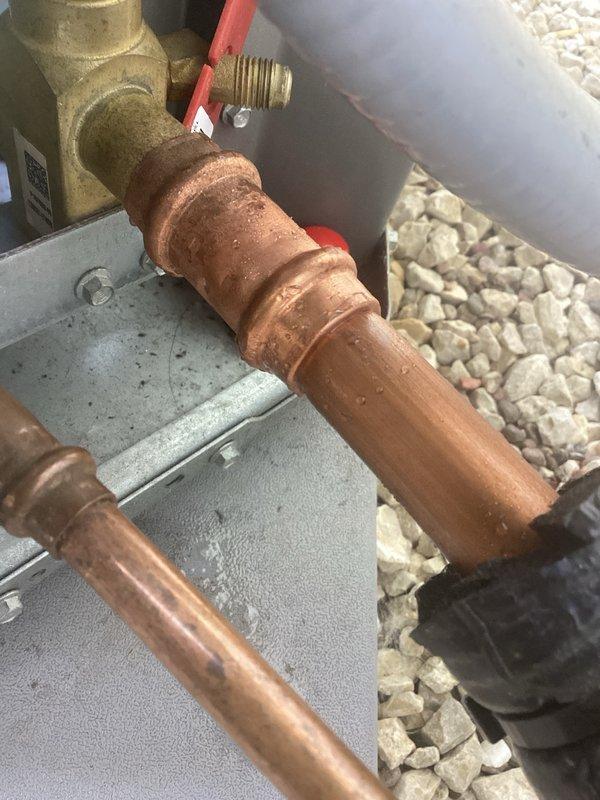 Responded to no cooling complaint on residential air conditioning system installed five months prior. Upon inspection, identified refrigerant leak at press fitting connection on service valve. Replaced defective service valve to restore system integrity and proper cooling operation.