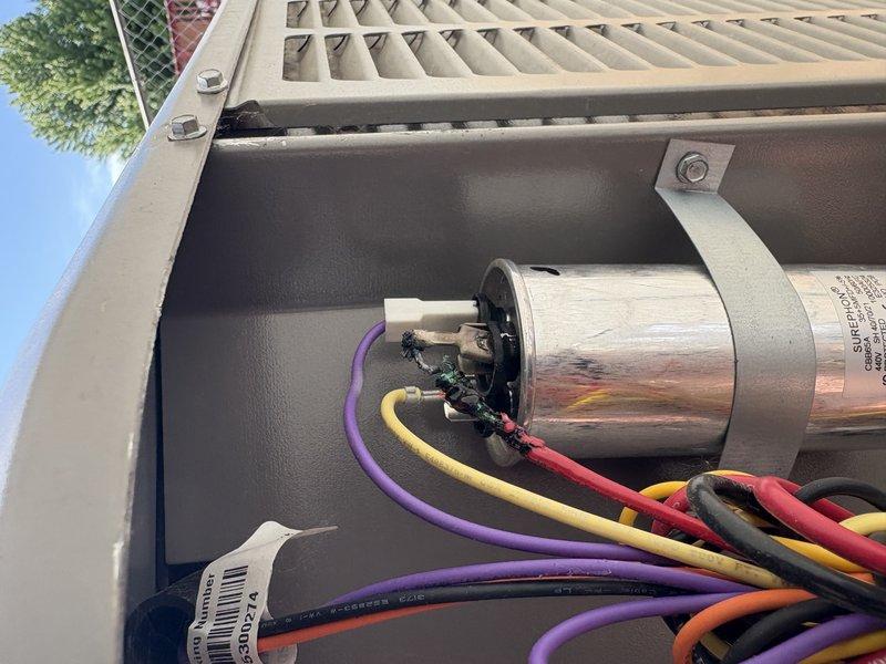 Responded to no cooling complaint on residential air conditioning system. Upon inspection, discovered burnt wiring and failed capacitor at outdoor condensing unit. Removed damaged wire section, installed new wiring connections, and replaced defective run capacitor. Verified proper electrical connections, tested system operation, and confirmed unit cooling properly. System restored to normal operation.
