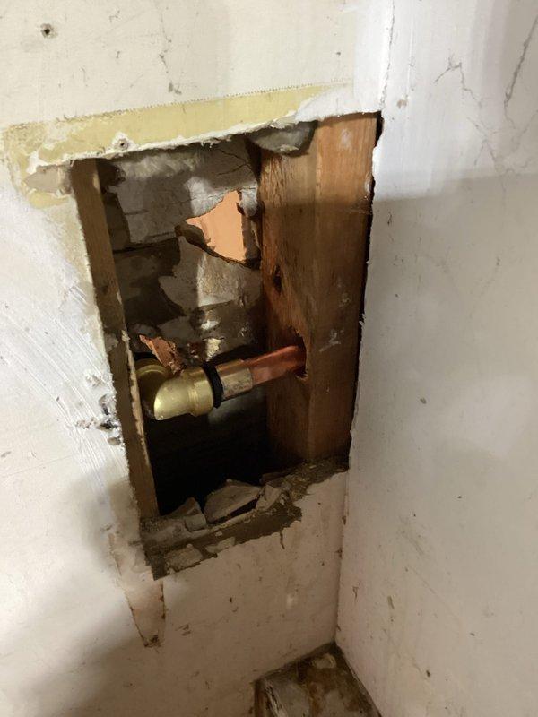 Responded to outdoor faucet leak and discovered burst hose bibb with leaking pipe. Accessed plumbing through interior wall opening, removed failed hose bibb assembly, and installed new replacement unit with proper fittings. Restored water supply to home and verified system operated without leaks upon completion.