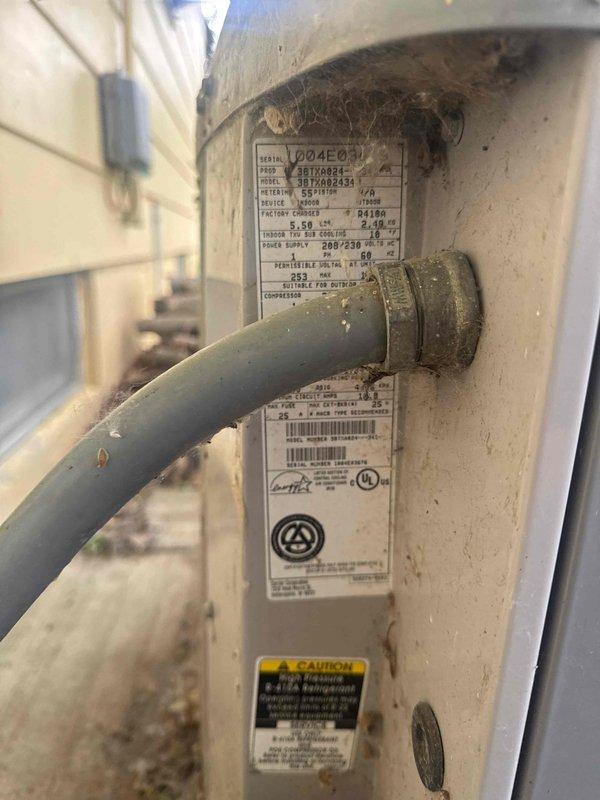 Responded to no cooling complaint on Carrier air conditioning system. Upon arrival, confirmed condenser fan motor was not operating. Diagnosed failed dual run capacitor at outdoor unit. Documented equipment condition with photos showing weathered condenser unit with accumulated debris and environmental wear. Provided written estimate for capacitor replacement to restore system operation, as property owner was unavailable for approval at time of service.