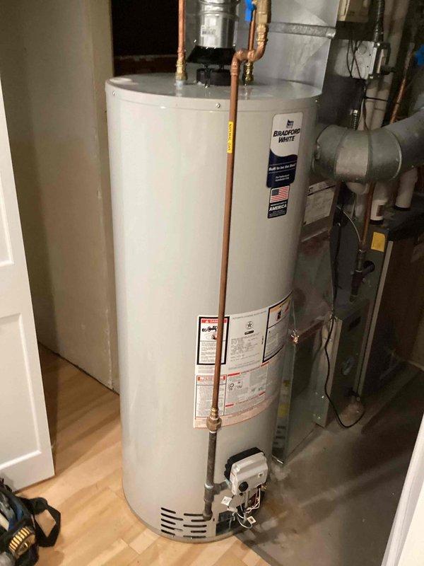 Responded to callback for non-functioning Bradford White water heater. Upon inspection, assessed existing 40-gallon propane unit and determined replacement necessary. Provided estimate for new 40-gallon power vent propane water heater installation, documented existing equipment configuration including copper supply lines, gas control valve assembly, and power vent connections for replacement specifications.