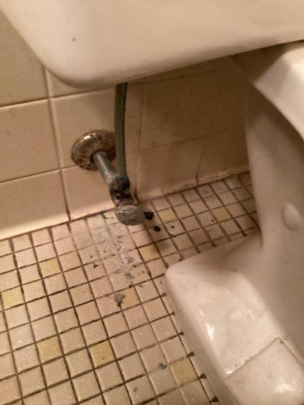 Responded to a main floor toilet leak caused by a heavily corroded and failing angle stop valve. Shut off the water supply to the home, then removed the deteriorated valve and old toilet supply line. Installed a new angle stop valve and supply line, restored water service to the residence, and verified proper operation with no leaks detected.