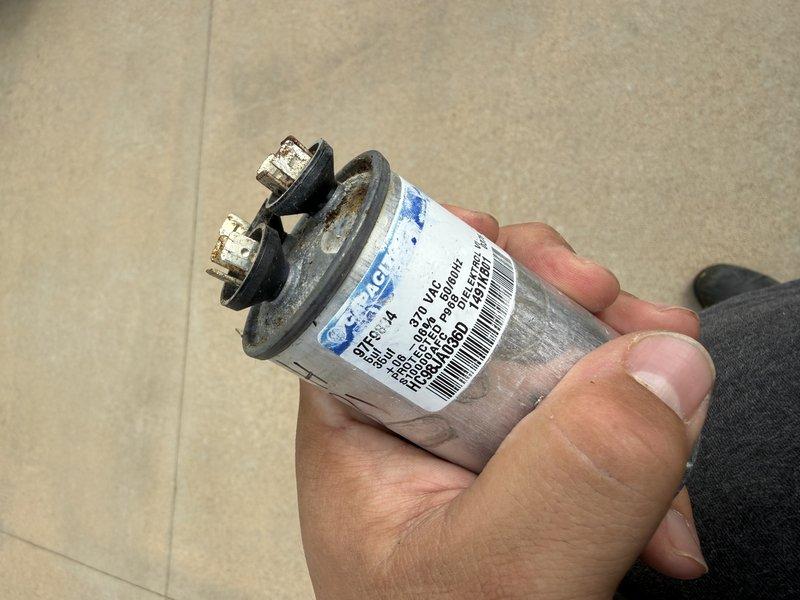 Responded to no cooling condition affecting entire residence. Diagnosed failed compressor capacitor on outdoor condensing unit. Removed defective capacitor and installed replacement component, restoring system to proper operation.