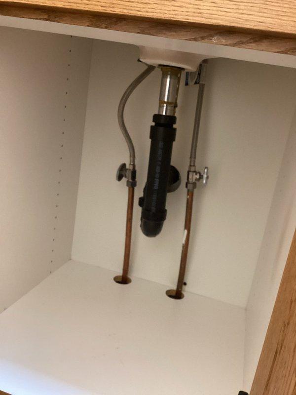 Completed faucet replacement on white double-basin kitchen sink, installing new white single-handle faucet with proper connection to existing copper supply lines and shut-off valves. Provided estimate for future sink replacement and consulted on backsplash tile options currently being evaluated for kitchen renovation.