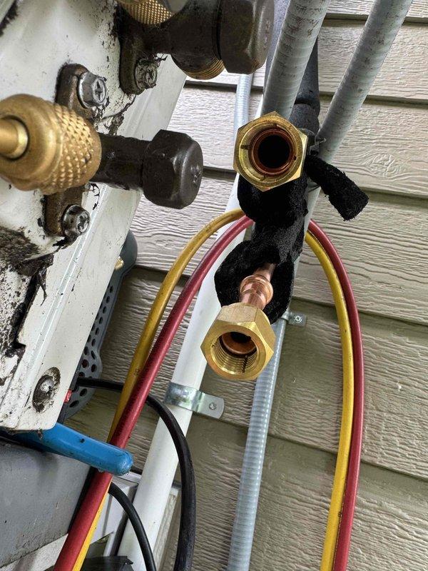 Responded to mini split system callback and diagnosed refrigerant leak at exterior line set connections. Replaced faulty flare fittings on both liquid and suction lines, evacuated system to proper vacuum levels using micron gauge, and recharged unit to manufacturer specifications. Verified proper system operation with diagnostic equipment and confirmed all connections leak-free before completing service.