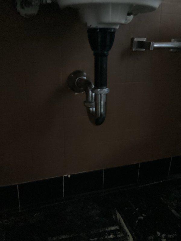 Returned to property to complete lavatory faucet installation in bathroom. Successfully installed white porcelain wall-mounted sink with chrome two-handle faucet featuring traditional cross-handle design. Connected all supply lines and drain assembly, including P-trap installation with proper venting to prevent sewer gas infiltration. Verified proper water flow, tested both hot and cold water handles for functionality, and confirmed pop-up drain stopper operation. All plumbing connections secured and leak-tested to ensure system integrity.