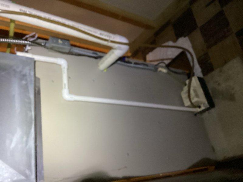 Responded to service call for water leaking on floor near furnace from air conditioning system. Upon arrival, confirmed water accumulation on floor in vicinity of indoor air handler unit. Diagnosed clogged condensate drain line as source of water overflow. Cleared blockage by blowing through condensate line to restore proper drainage. Verified system draining correctly and no further water accumulation occurring.