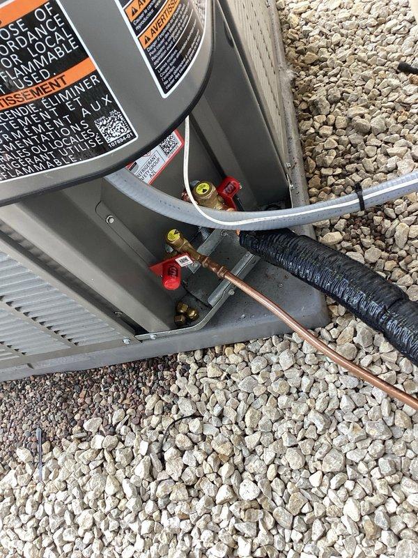 Responded to service call for refrigerant leak on outdoor condensing unit. Upon arrival, diagnosed leak at service valve connection on refrigerant line. Replaced defective service valve with new brass valve assembly, pressure tested system to verify repair integrity, and recharged unit to manufacturer specifications. Unit tested and operating normally upon departure.