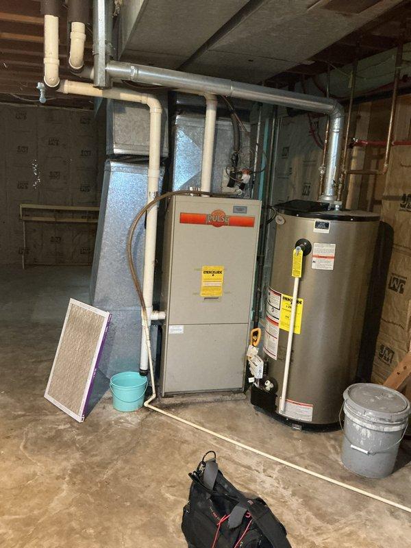 Responded to no cooling complaint and confirmed low refrigerant condition on residential air conditioning system. Evaluated Bryant HVAC equipment in basement mechanical room and inspected outdoor condensing unit. Due to low refrigerant levels indicating potential leak and the age and condition of the equipment, recommended property manager be contacted for further assessment before proceeding with repairs or refrigerant recharge.