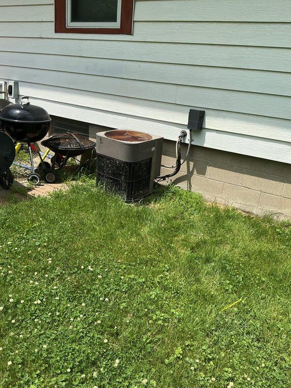 Responded to no cooling complaint and confirmed low refrigerant condition on residential air conditioning system. Evaluated Bryant HVAC equipment in basement mechanical room and inspected outdoor condensing unit. Due to low refrigerant levels indicating potential leak and the age and condition of the equipment, recommended property manager be contacted for further assessment before proceeding with repairs or refrigerant recharge.