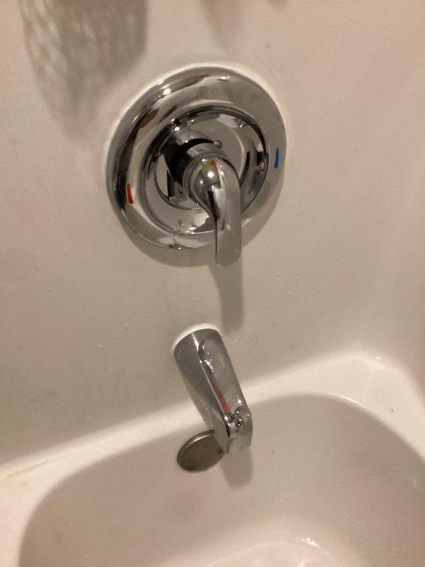 Responded to a shower faucet dripping issue caused by a bent tub spout pipe and faulty Moen Posi-Temp cartridge. Upon inspection, found the copper pipe extending from the wall for the tub spout was bent at a 45-degree angle, and the shower valve cartridge was failing to shut off water completely. Replaced the damaged tub spout pipe with new copper pipe and installed a new tub spout with diverter. Removed the defective Moen Posi-Temp cartridge from the valve body and installed a new replacement cartridge. Restored water supply to the home and tested the system to confirm proper operation with no leaks and full shutoff capability.