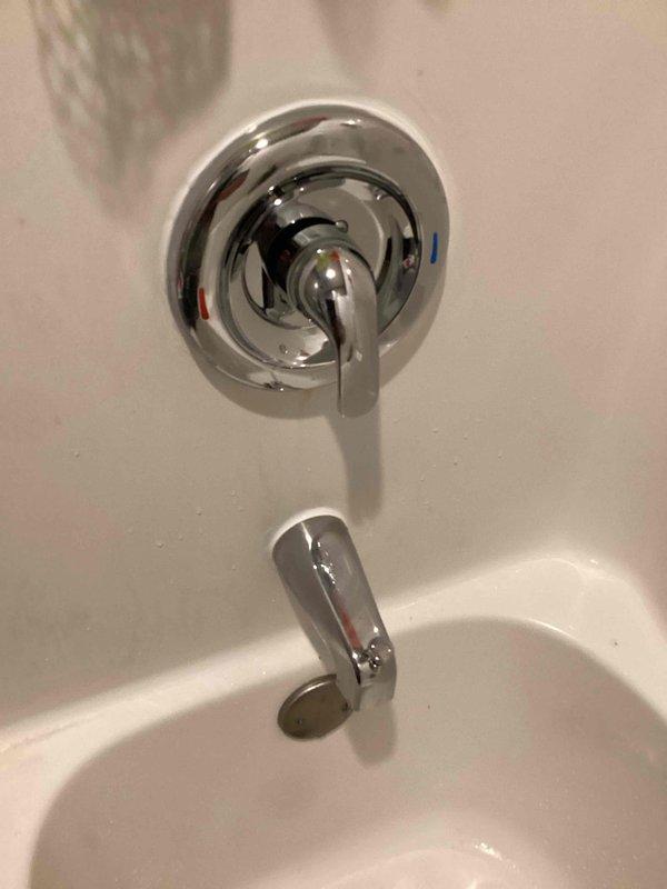 Responded to a shower faucet dripping issue caused by a bent tub spout pipe and faulty Moen Posi-Temp cartridge. Upon inspection, found the copper pipe extending from the wall for the tub spout was bent at a 45-degree angle, and the shower valve cartridge was failing to shut off water completely. Replaced the damaged tub spout pipe with new copper pipe and installed a new tub spout with diverter. Removed the defective Moen Posi-Temp cartridge from the valve body and installed a new replacement cartridge. Restored water supply to the home and tested the system to confirm proper operation with no leaks and full shutoff capability.