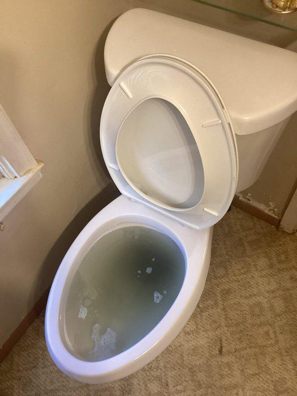 Responded to service call for upstairs toilet that was not flushing properly. Upon inspection, determined the issue was a clogged main line rather than an isolated toilet blockage. Accessed plumbing infrastructure through existing wall panel to assess main drain line condition and confirmed diagnosis. Provided referral for main line clearing service due to scope of work required.