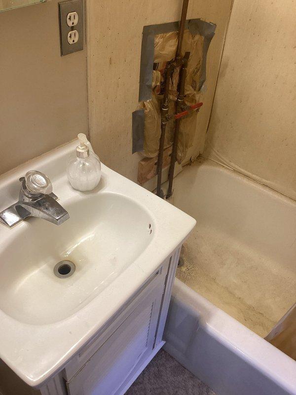 Responded to service call for upstairs toilet that was not flushing properly. Upon inspection, determined the issue was a clogged main line rather than an isolated toilet blockage. Accessed plumbing infrastructure through existing wall panel to assess main drain line condition and confirmed diagnosis. Provided referral for main line clearing service due to scope of work required.