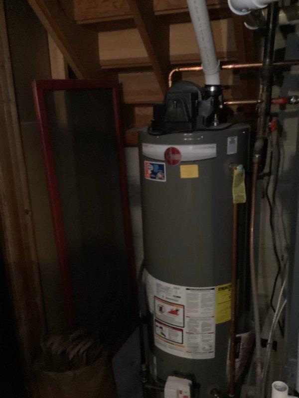 Completed electrical inspection for final rough mechanical (FRM) phase. Identified washing machine circuit lacking required GFCI protection per current electrical code requirements. Documented findings with photographs of kitchen electrical outlets and basement utility area where water heater and plumbing systems are located. Provided estimate for GFCI protection installation to bring washer circuit into code compliance.