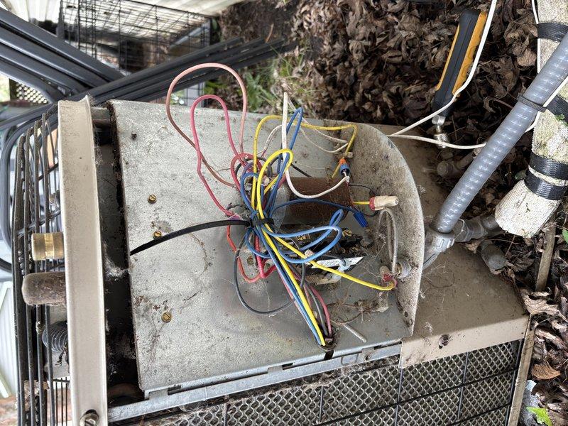 Responded to no cooling call on residential air conditioning system. Upon arrival, confirmed outdoor condensing unit was not operating. Diagnostic testing revealed failed dual run capacitor and tripped high pressure switch. Accessed electrical compartment and inspected internal wiring and components. Due to age of system (10+ years), replacement parts are no longer available from manufacturer. Advised customer that complete system replacement is necessary as repair is not feasible. Unit cannot be restored to operation without unavailable components.