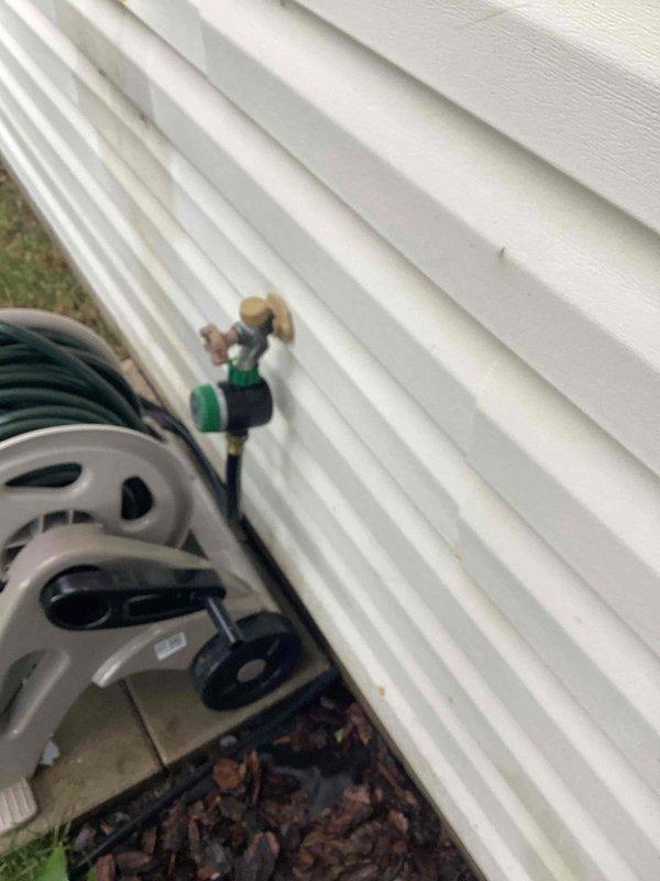 Responded to service call for outdoor hose bibb leaking during operation. Upon inspection, identified loose packing nut on backyard hose bibb assembly. Tightened packing nut to proper torque specification and tested faucet operation under full water pressure. Verified complete leak elimination and confirmed proper functionality of valve mechanism.