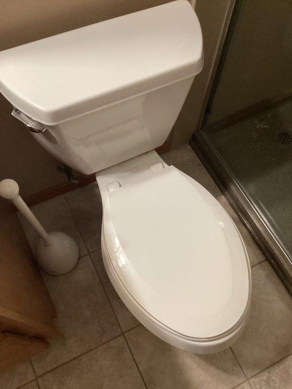 Responded to service call for toilet requiring reset. Upon inspection, discovered loose mounting bolts and nuts securing toilet to floor flange. Tightened all mounting hardware and installed shims to level and stabilize the fixture. Conducted multiple flush tests to verify proper operation and confirm no leaks or rocking movement. Toilet now functions correctly with secure mounting to flange.