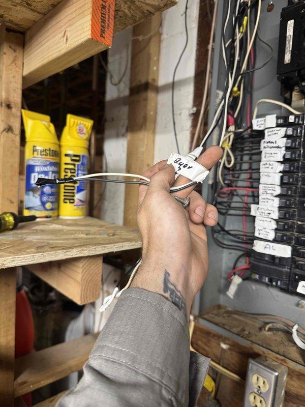 Responded to no cooling complaint and found no power at air handler. Accessed attic space and moved ductwork to diagnose system. Traced electrical issue to breaker panel where a disconnected wire was discovered with no available breaker positions. Documented findings with photos showing the disconnected wiring at the electrical panel and attic access area. Advised customer that an electrician would need to properly reconnect the wire and address breaker panel capacity before air conditioning system could be restored to operation.