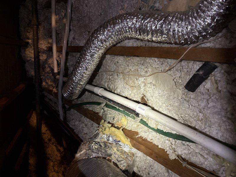Responded to service call for reported AC leak in attic space. Upon inspection, discovered the air conditioning condensate drain line had snapped, causing water discharge into the attic area. Removed the damaged section of PVC pipe and installed new replacement piping to restore proper drainage function. Verified system operation and confirmed condensate is now draining correctly through the repaired line.
