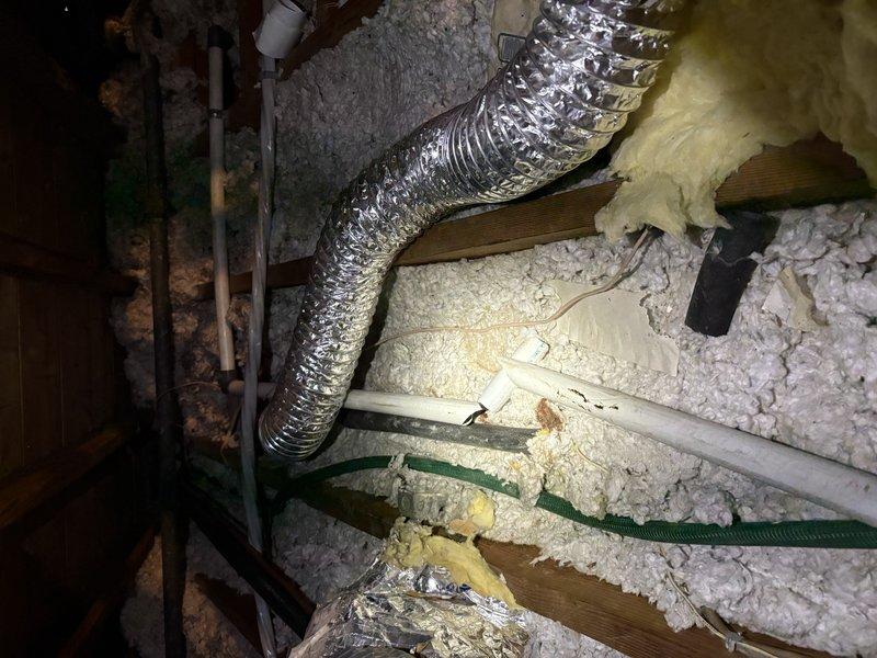 Responded to service call for reported AC leak in attic space. Upon inspection, discovered the air conditioning condensate drain line had snapped, causing water discharge into the attic area. Removed the damaged section of PVC pipe and installed new replacement piping to restore proper drainage function. Verified system operation and confirmed condensate is now draining correctly through the repaired line.