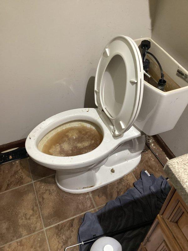 Responded to a clogged toilet with sewage backup into the bathroom. Upon arrival, diagnosed that the blockage was located beyond the toilet fixture in the main drain line. Assessed the situation and determined that specialized drain cleaning equipment would be required to clear the obstruction in the building's plumbing system, resulting in a referral for additional service.