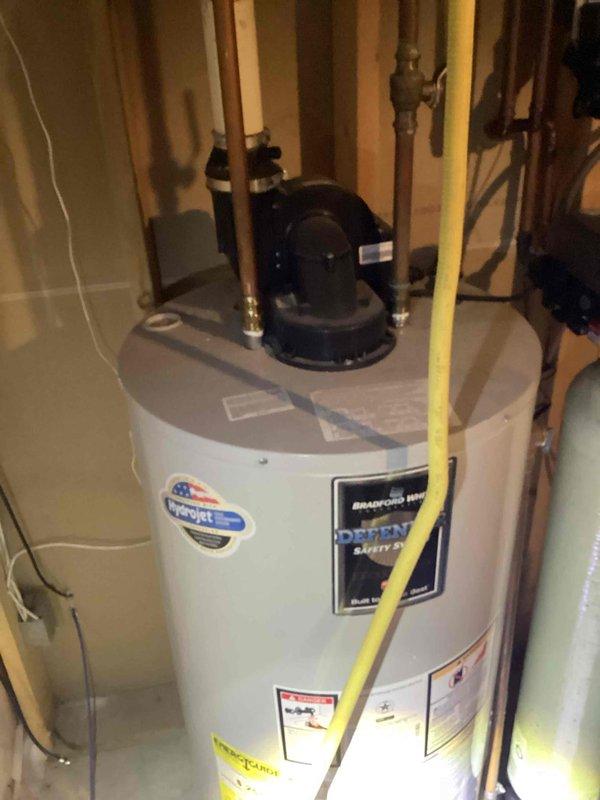 Responded to service call for leaking water heater. Upon arrival, diagnosed tank failure with active water leak originating from the tank body of the existing unit. Documented conditions with photographs showing 50-gallon natural gas power vent water heater with compromised tank integrity. Provided estimate for replacement with new 50-gallon short power vent natural gas water heater.