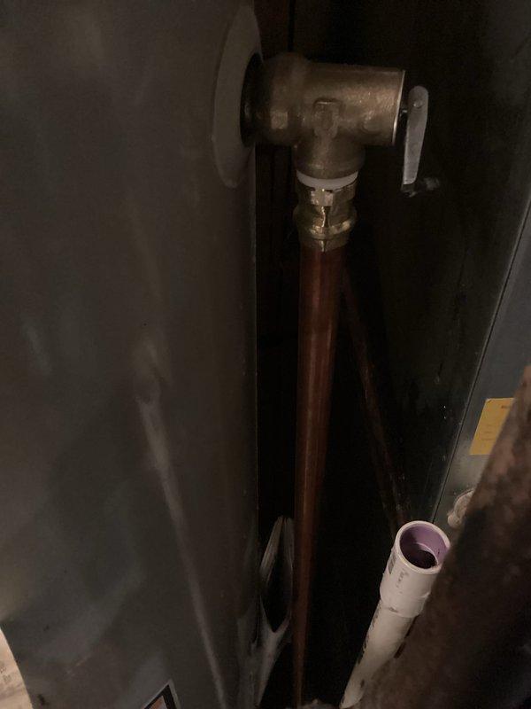 Responded to water heater T&P valve leak caused by spring mechanism stuck in open position, resulting in continuous water discharge. Removed failed temperature and pressure relief valve and installed new replacement unit, restoring proper function and eliminating leak. Advised homeowner to add crystal salt to water softener system for optimal performance.
