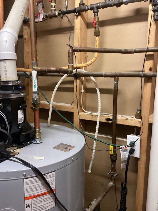 Responded to service call for non-functioning water softener system. Upon inspection, determined the existing water softener unit was inoperable and required full replacement. Successfully removed the failed water softener and installed a new blue cylindrical water softener tank with electronic control head, brine tank, and associated plumbing connections in the utility room. Verified proper operation of the new system and ensured all connections to existing water heater and household plumbing were secure and functioning correctly.