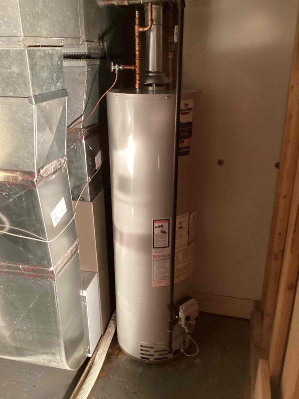 Completed full replacement of residential water heater in basement utility area. Drained and disconnected existing unit, then removed and disposed of old water heater. Installed new 40-gallon Bradford White atmospheric vent water heater in same location. Made all necessary plumbing connections using copper piping, filled tank, performed system startup, and verified proper operation before departure.