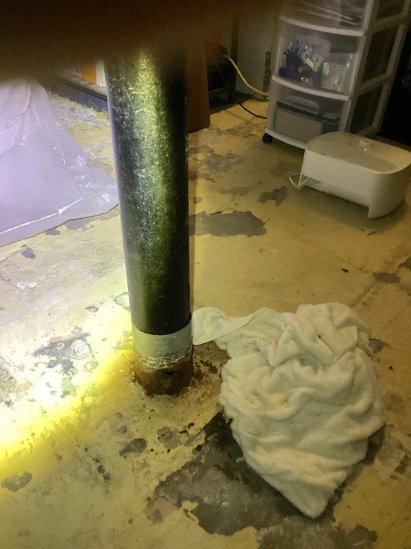 Responded to service call for leaking cast iron drain line. Upon inspection, discovered a quarter-sized hole in the 4" cast iron drain pipe near floor level, with an additional 6-8 inches of severely corroded pipe extending toward the slab foundation. The corroded section exhibited significant deterioration with rust and structural compromise requiring replacement. Documented the damage with photographs showing the extent of corrosion at the pipe base and water damage to the surrounding floor area. Due to the location of the damaged section entering the slab, concrete floor demolition will be necessary to access and replace the affected drain line. Forwarded all inspection findings and photographic documentation to schedule follow-up appointment for the required excavation and pipe replacement work.