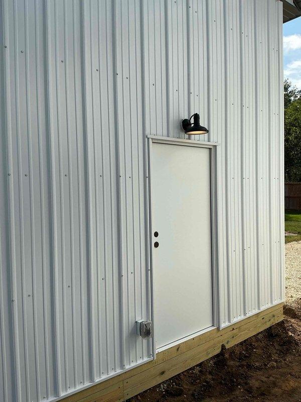 Completed full electrical rough-in and trim work for detached garage structure. Installed complete wiring system, circuit breaker panel with properly labeled circuit directory, and exterior gooseneck lighting fixture above entry door. Work was coordinated with scheduled rough-in inspection and all installations completed to code specifications.