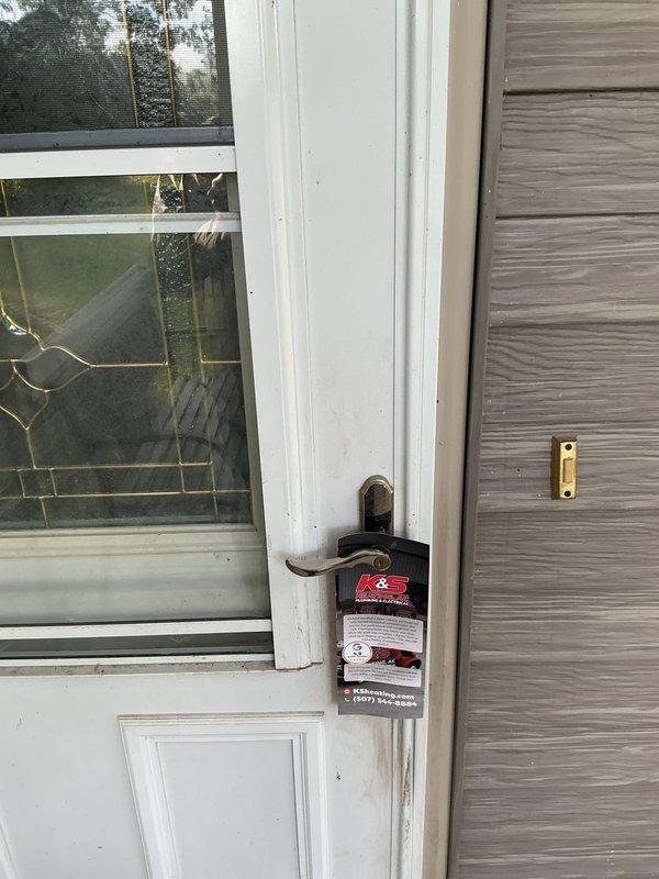 Responded to no-cooling call for attic-mounted air conditioning unit. Customer was not present upon arrival despite multiple attempts to make contact. Left door hanger with service information and contact details for customer to reschedule or discuss temporary repair options, as unit is scheduled for replacement with new installation.