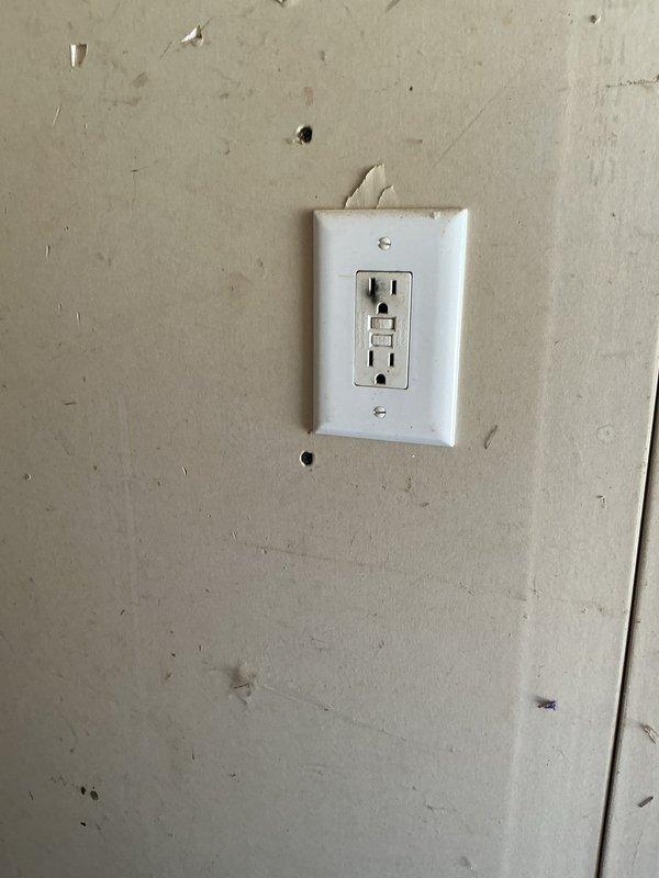 Responded to electrical hazard in garage where existing GFCI outlet had failed due to overheating and charring. Removed damaged receptacle, inspected circuit wiring for heat damage, and installed new GFCI outlet to restore safe power supply and ground fault protection to the garage circuit.