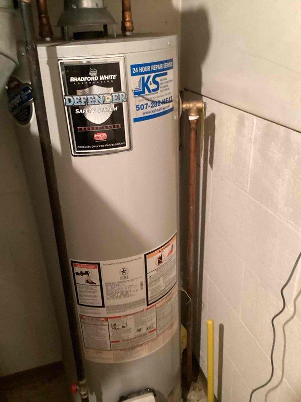 Installed Water Right Impression series water softener system in utility room, completing all necessary plumbing connections with copper piping and integrating the unit with existing water heater infrastructure. The installation included mounting the digital control unit, establishing proper drainage, and ensuring all connections meet code requirements for optimal water treatment performance.