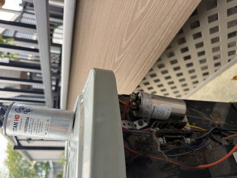 Responded to no cooling complaint on American Standard air conditioning unit. Diagnosed failed capacitor preventing compressor operation. Replaced defective dual run capacitor with new TITAN HD capacitor, restoring proper system function and cooling capability.