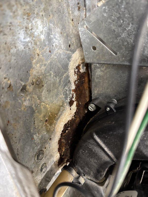 Performed comprehensive AC and furnace maintenance on a 2002 American Standard Allegiance 10 system. Identified critical furnace venting issue with extensive water damage present in the unit and visible corrosion on mounting components. Discovered outdoor condensing unit was significantly low on R-22 refrigerant, requiring attention. Documented equipment conditions with photos showing manufacturer specifications, water damage evidence, and rust deterioration on internal brackets. Recommended preventative maintenance plan to address identified deficiencies.